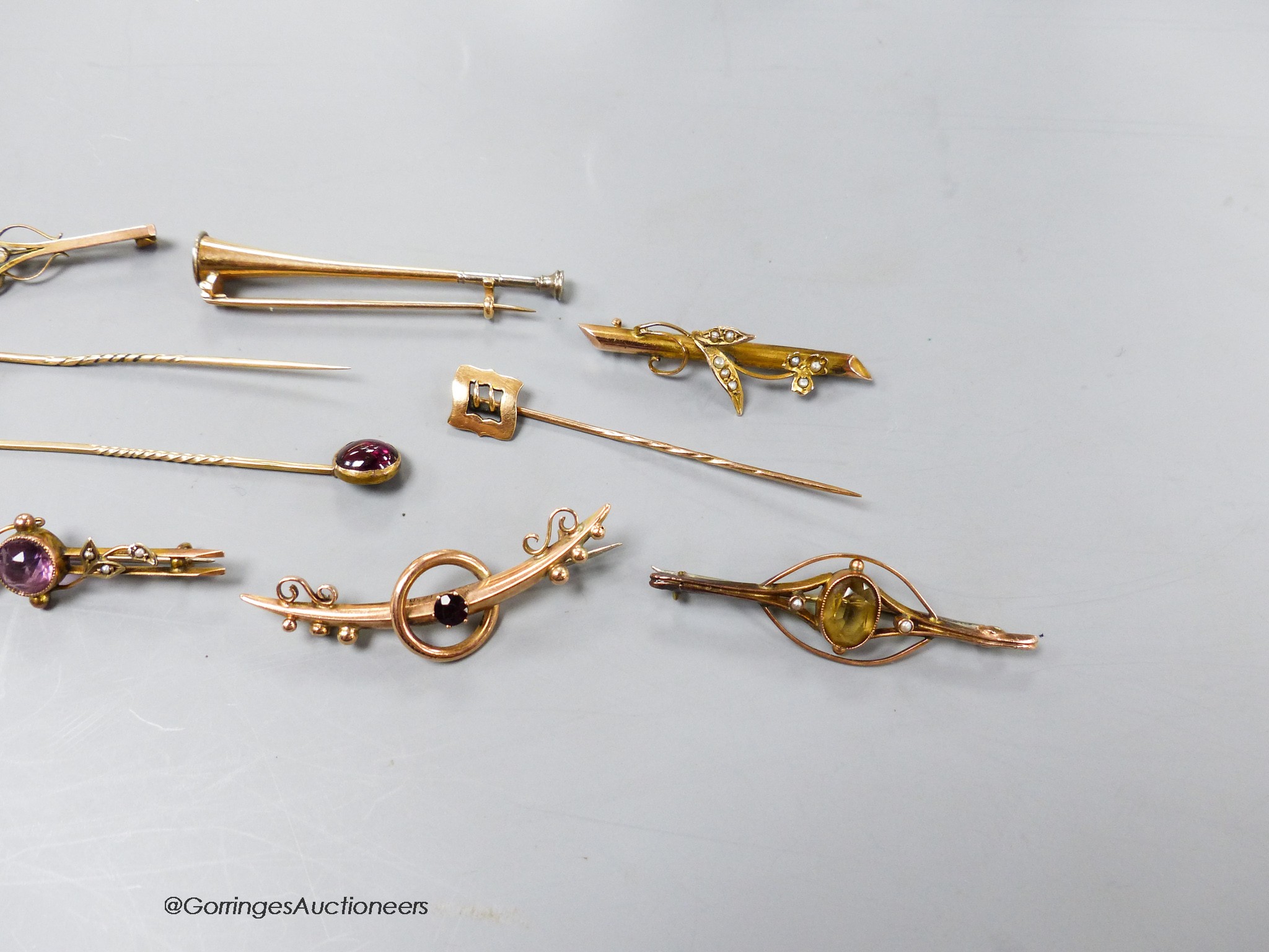 Four assorted early 20th century 9ct and gem set bar brooches, gross 9.1 grams, two yellow metal bar brooches including hunting horn and two yellow metal gem set stick pins, gross 10 grams and a 15ct stick pin, 1.4 grams